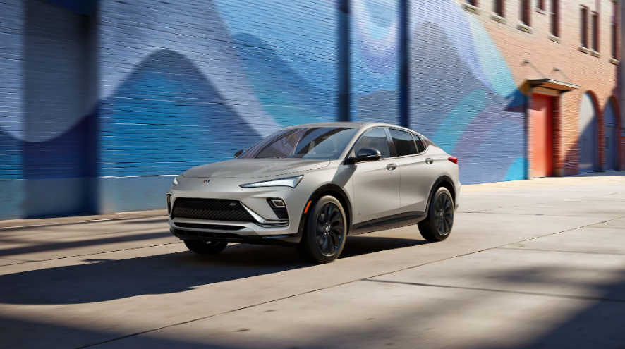 A 2026 Buick Envista driving by stylish art in Akron, OH