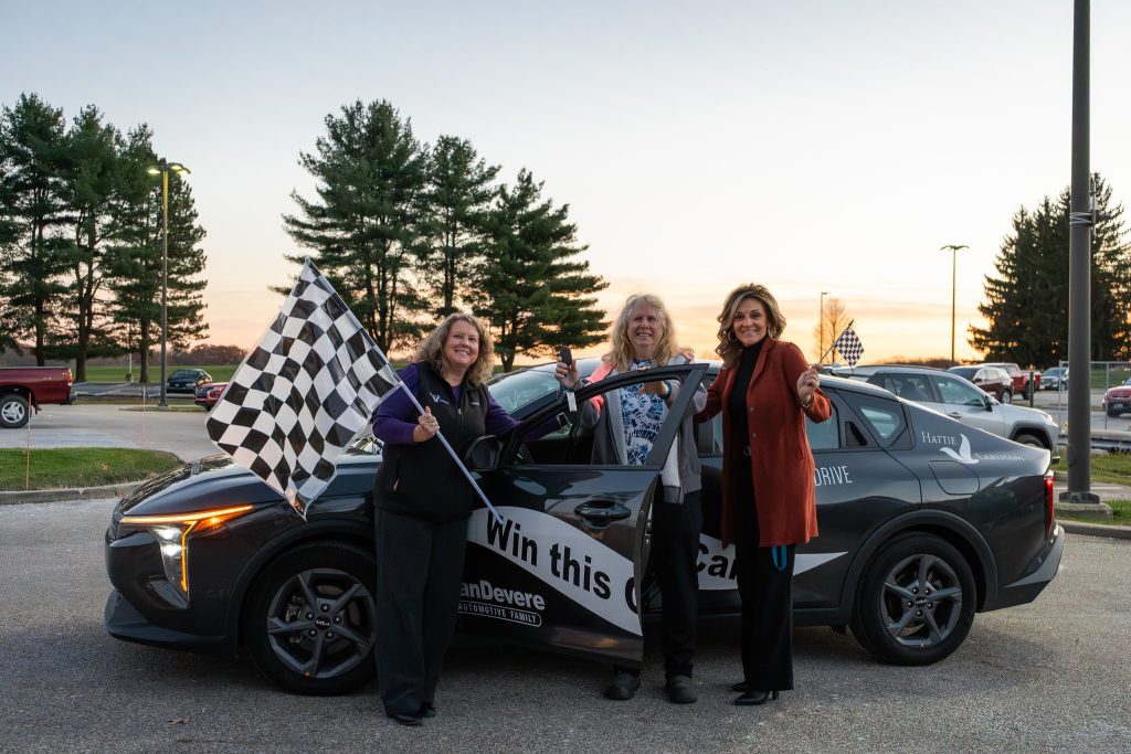 Leslie, the proud new owner of a stunning 2025 KIA K4, after winning the Hattie Larlham Thrive & Drive Car Raffle