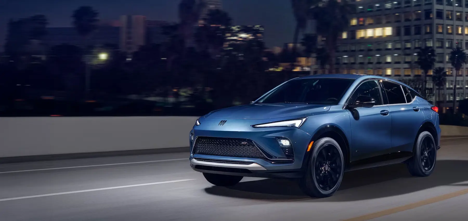 Blue Buick driving at night